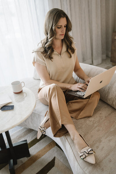 Wedding planner working on laptop in her hotel room