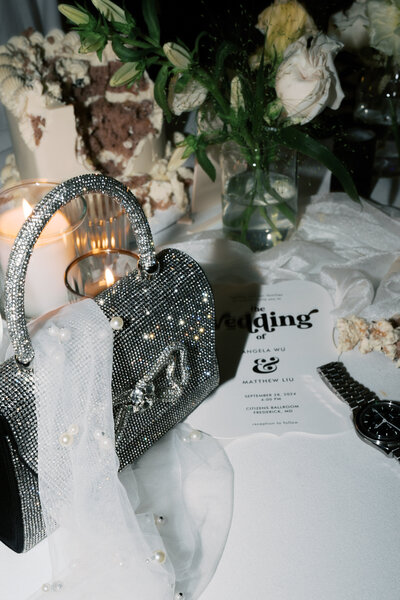 Close up of engagement ring surrounded by pink flowers and other jewelry