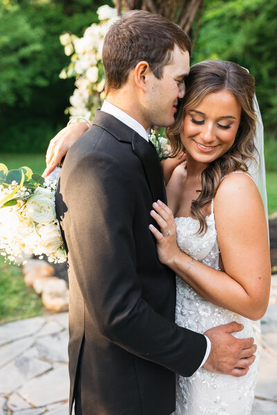 groom kissing his bride on the head