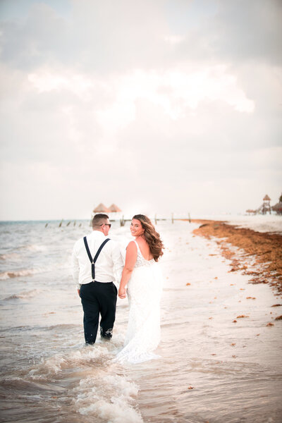 couple walking down the beach  in Mexico