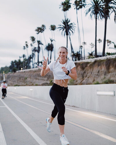 Coach Be Wilcock running outdoors during HER Sports Club’s Half Marathon training program.