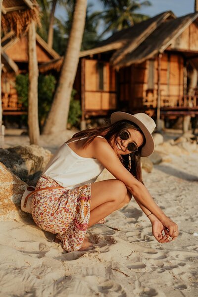 Woman with sunglasses, dressed for summer on vacation at the beach