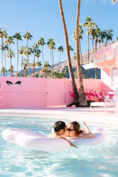 LGTBQ couple playing in a pool