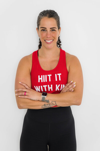 Kim wearing a Hiit it with Kim tank top encouraging people to work with her in  one-on-one health and wellness coaching