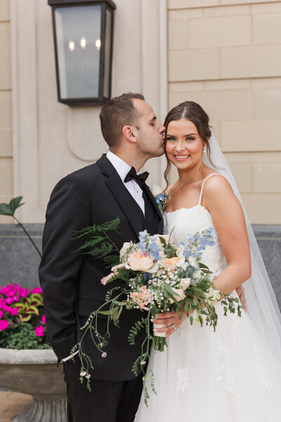 Bride and groom posing in front of  trees