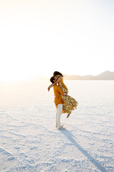 Couple in bright clothing during their engagement session at the salt flats. 