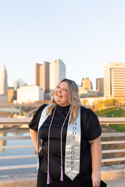 University of Cincinnati graduate tosses cap in celebration on stadium field