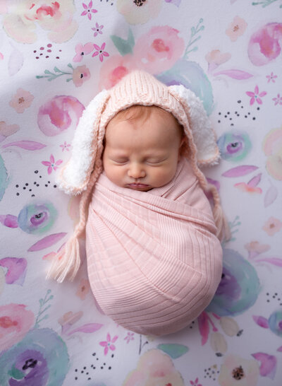 An adorable baby girl in bunny ears at her newborn session. Diane Owen Photography.