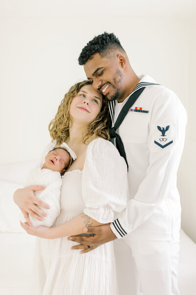 mom and dad holding baby and cuddling by spokane photographer