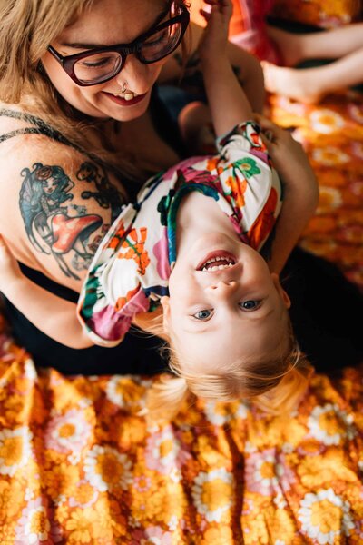 Mother holding upside down daughter during family photoshoot Melbourne 