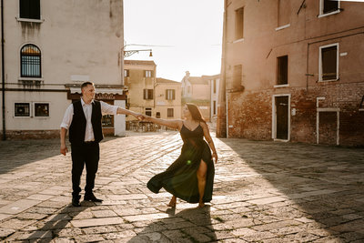 sweet couple stands and smiles after they got engaged