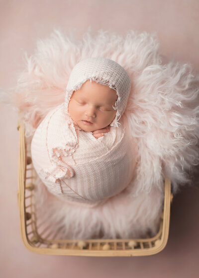 Newborn baby girl in pink sleeping
