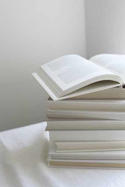A book laying open on a sofa.