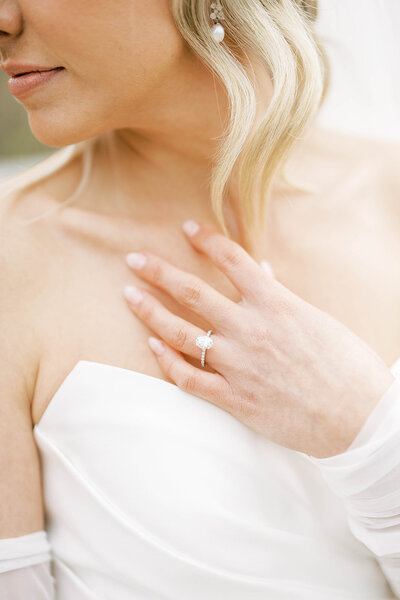 Bride with blonde hair poses with engagement ring on wedding day in Harrisburg