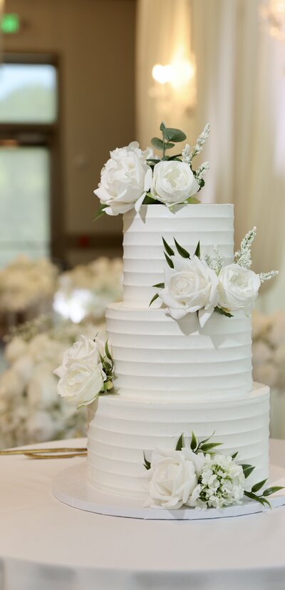 Timeless Textured White Wedding Cake with Florals and Hints of Greenery