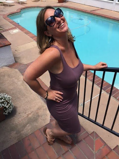 Picture of Kerri in sunglasses next ot swimming pool