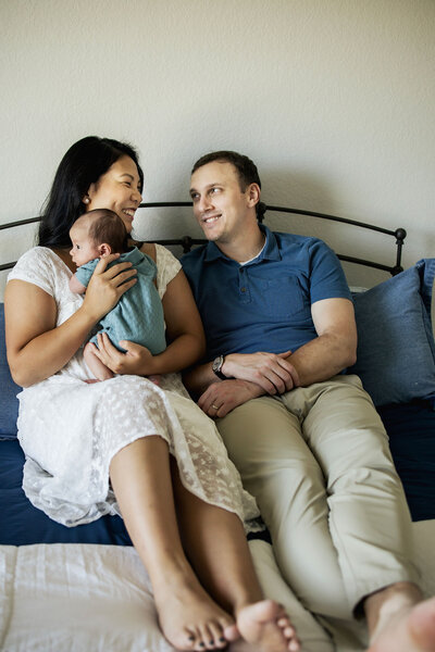 couple with their newborn baby at a home session in Plano Texas