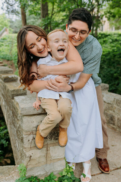 Couple hugs their boy