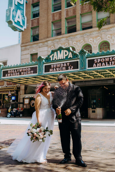 couple eloping in florida and popping champagne