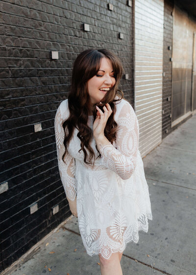 Girl smiling in white lace dress
