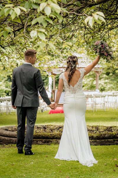 Bride and groom sharing a joyful embrace at Holdsworth House, captured by Yorkshire wedding photographer.

