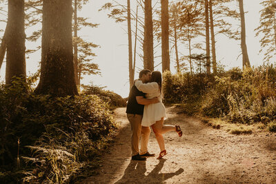 Couple kissing each other with a forest view