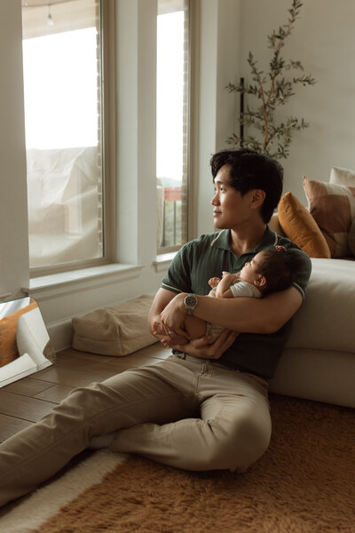 Dad holding a newborn baby