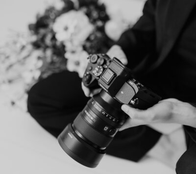 photographer in the studio posing sitting down with her camera