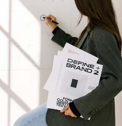 brisbane based website designer, a woman circling a date on a calendar whilst standing to her side