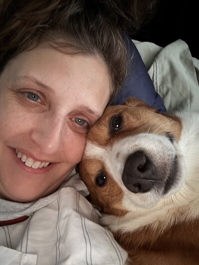 selfie of Heidi and George her dog snuggling.