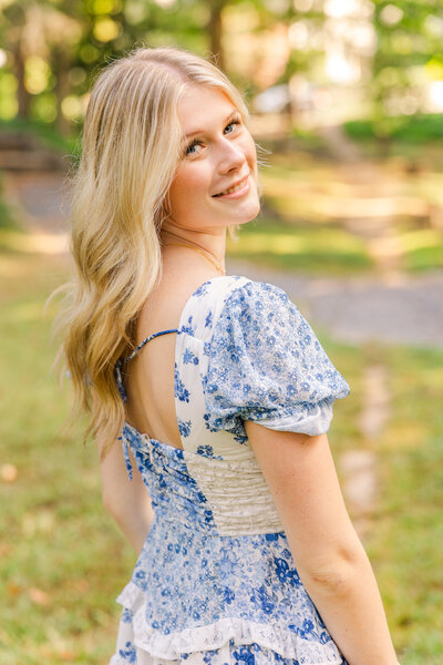 Outdoor Atlanta high school senior portraits or girl wearing a blue and white dress in a park with photographer Laure photography