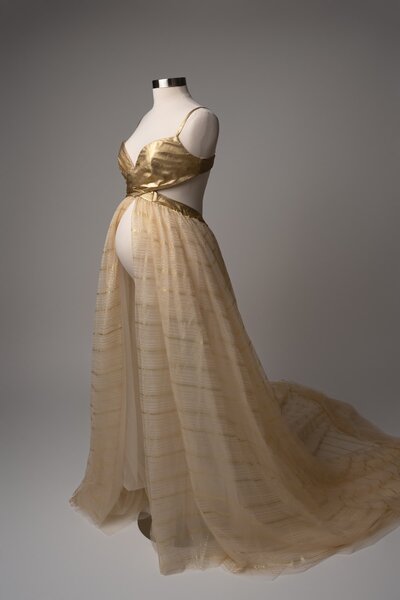 Metallic gold halter gown with high slit, styled for studio maternity portraits