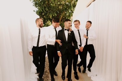 Groom Groomsmen Walking Together - Bre & Chris | Converted Basketball Court Wedding – Featured in Brides Magazine