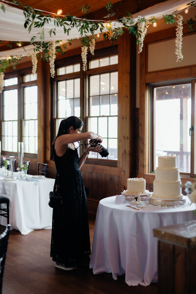 wedding photographer montana taking a picture of the wedding cake at a wedding reception