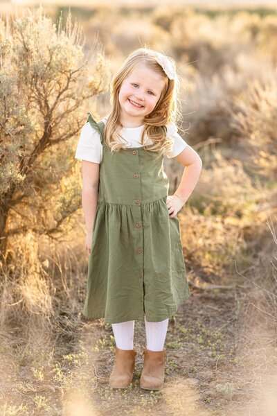 a little girl posing with her hand on her hip