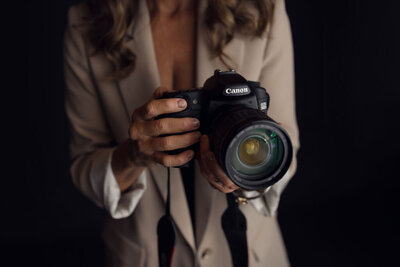 Author holds camera, symbolizing resilience and the power to capture stories of healing.