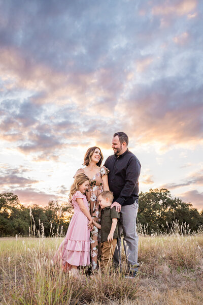 Family in a field at sunset
