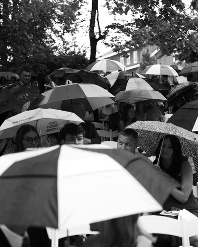 black and white documentary image during a rainy ceremony