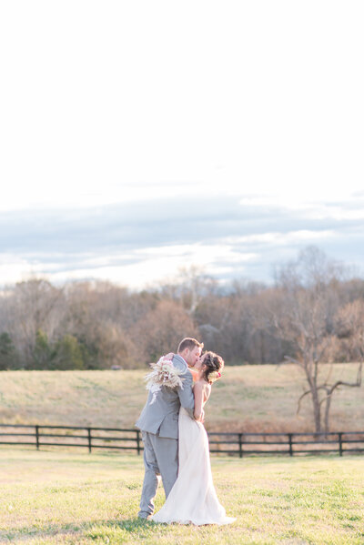 An engaged couple show off their love and celebrate their engagement at Scribner Bend Vineyards by Adrienne and Dani Photography
