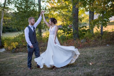bride and groom dancing outside