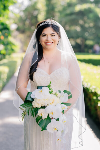 picture of bride smiling while holding her bridal bouquet taken by Southern California adventure elopement photographer