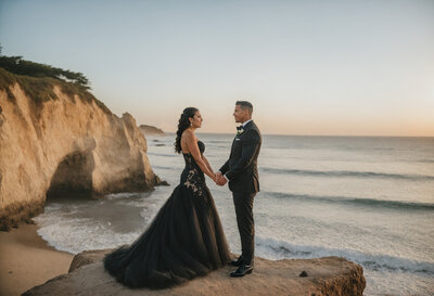 Enchanting photograph capturing a bride and groom sharing a tender kiss under a tree, enveloped by the natural beauty of Half Moon Bay.