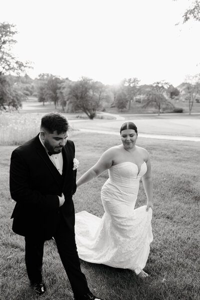 Groom kissing the bride on the cheek and the bride's hair is windblown