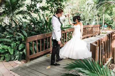 bride & groom standing on bridge