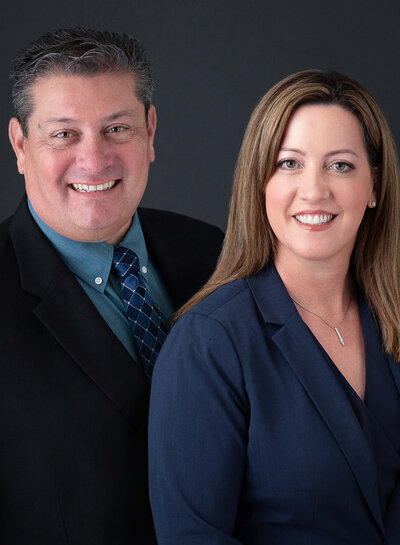 corporate headshots of a male and female standing together on a charcoal backdrop taken by Ottawa Headshot Photographer JEMMAN Photography Commercial