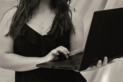 Black and white close up of samantha using her laptop