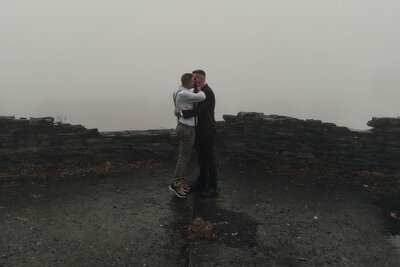 Couple sharing their first kiss in the fog