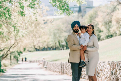 Family standing next to tall grass at the Gabriel Dumont Park in Saskatoon. Captured by Amanda Jordan Photography.