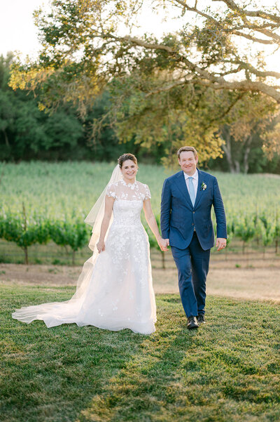 Bride and Groom holding hands during wedding ceremony in Italy. Photographed by luxury wedding photographer, Sarah Woods.