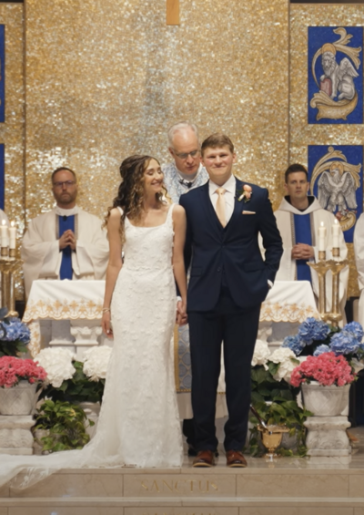 bride and groom standing together in a Catholic church